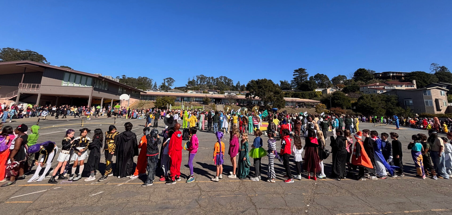 Madera students in costumes gathered on the blacktop for the school parade