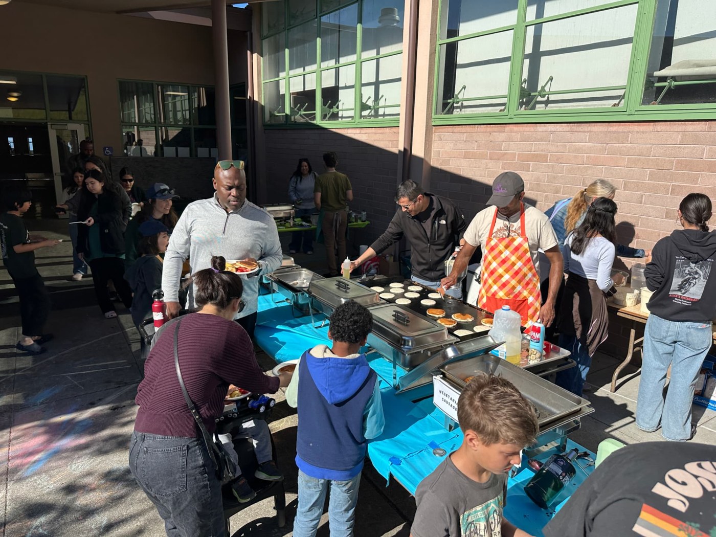 Madera families and volunteers sharing a pancake breakfast